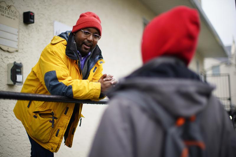 Greg Scott, a newly-elected Democratic member of Pennsylvania's House of Representatives, speaks with a person outside the Hospitality Center which helps people experiencing homelessness and poverty, in Norristown, Pa., Dec. 22, 2022. Scott is part of what House Democrats say is the most diverse incoming class of lawmakers in state history.