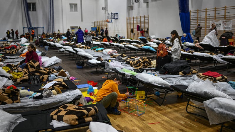 Women and children rest inside the sports hall of a primary school which has been converted to a refugee center on March 01, 2022 in Przemysl, Poland.