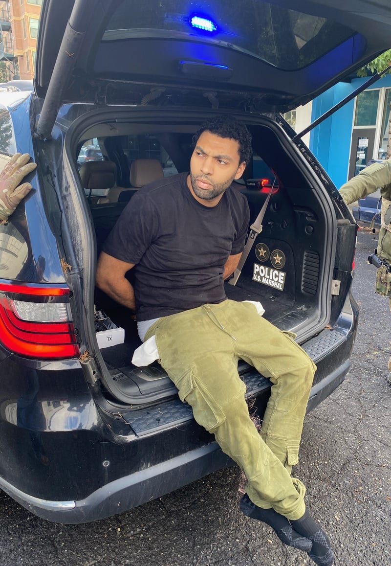 Suspect handcuffed in back of vehicle