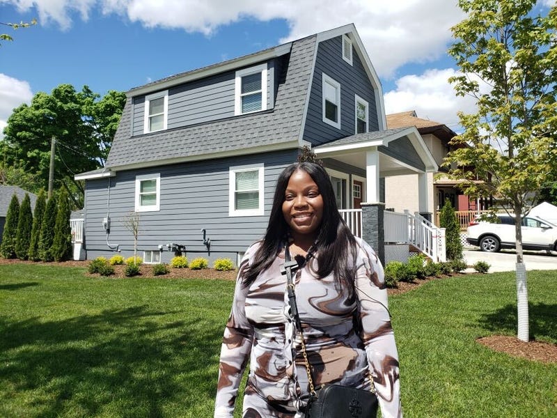 Woman in front of house