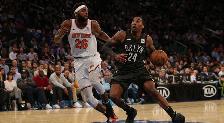 Nets forward Rondae Hollis-Jefferson drives against Knicks center Mitchell Robinson on Oct. 29, 2018, at Madison Square Garden.