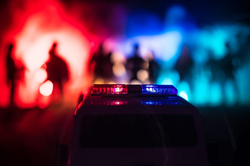 Police car at night with people in the background