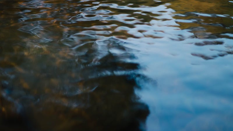Abstract motion blur of water in a river - stock photo