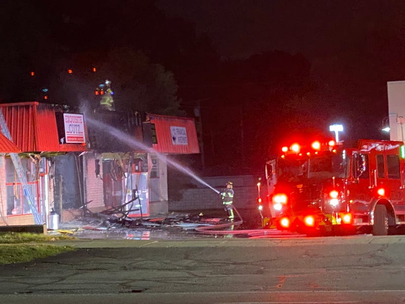 Firefighters in Wayne County have extinguished a large fire that burned through several businesses in a strip mall early Tuesday morning, officials said, but the cause remains "suspicious."