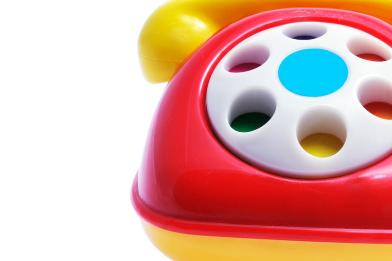 Red and yellow toy phone on white background