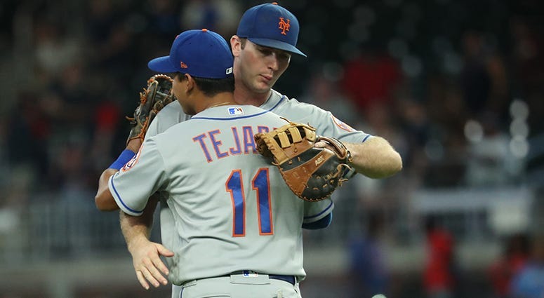 Ruben Tejada and Pete Alonso hug it out 