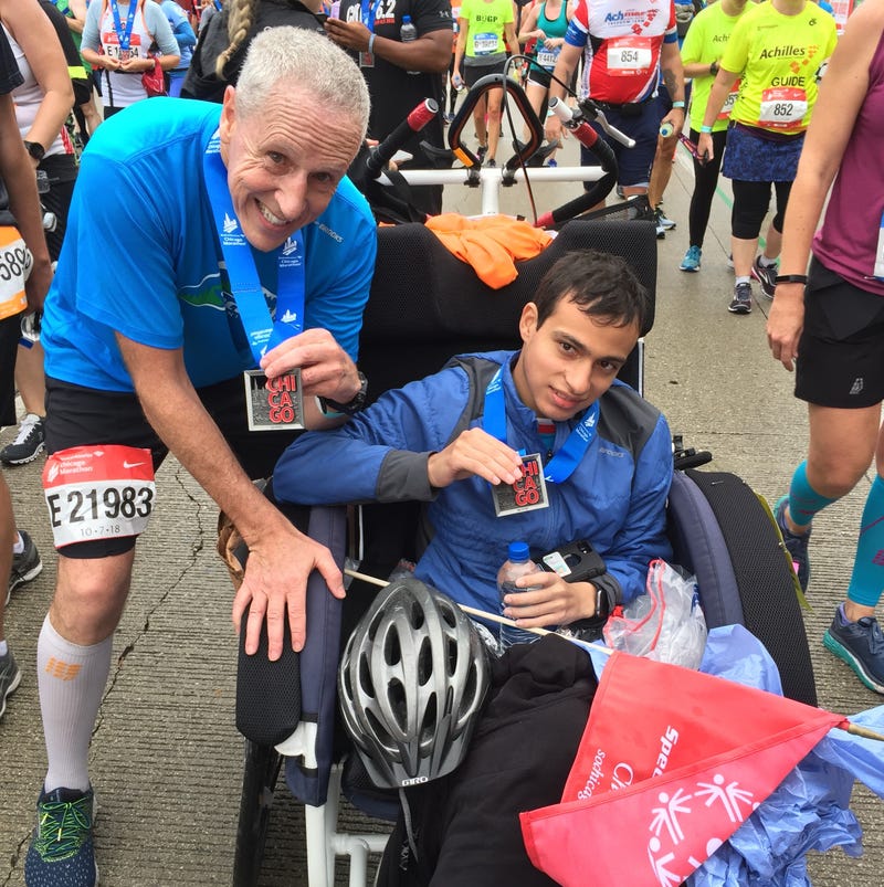 Runner next to man in wheelchair
