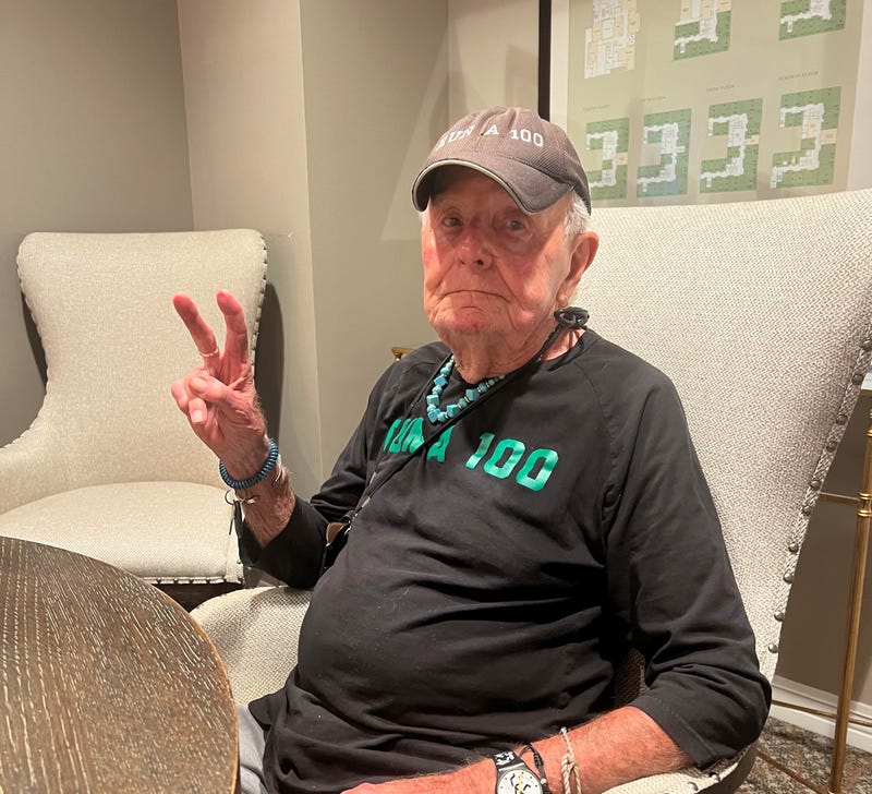 runner, 88, flashes Peace sign
