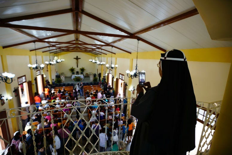 A Roman Catholic nun takes a photo with her phone at the Sacred Heart Church of Jesus in Sandino, Cuba. The church is the first new Catholic church to be built on the communist-run island since 1959.