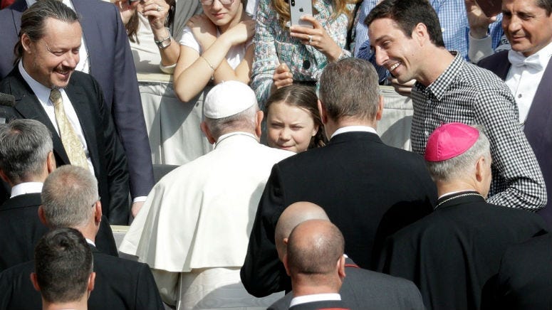 Pope Francis greets Swedish teenage environmental activist Greta Thunberg.