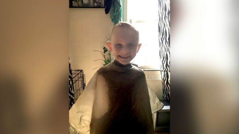 The body of a 5-year-old boy reported as missing last week was found wrapped in plastic in a shallow grave on Wednesday, and his parents have been charged with murder, police said.