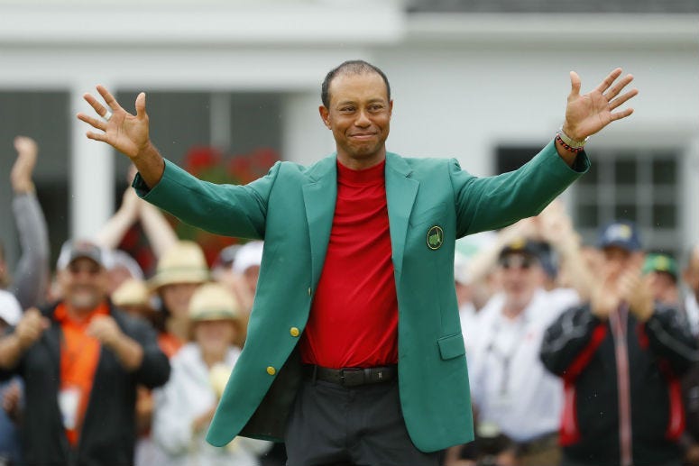 Tiger Woods of the United States smiles after being awarded the Green Jacket during the Green Jacket Ceremony after winning the Masters at Augusta National Golf Club on April 14, 2019 in Augusta, Georgia.