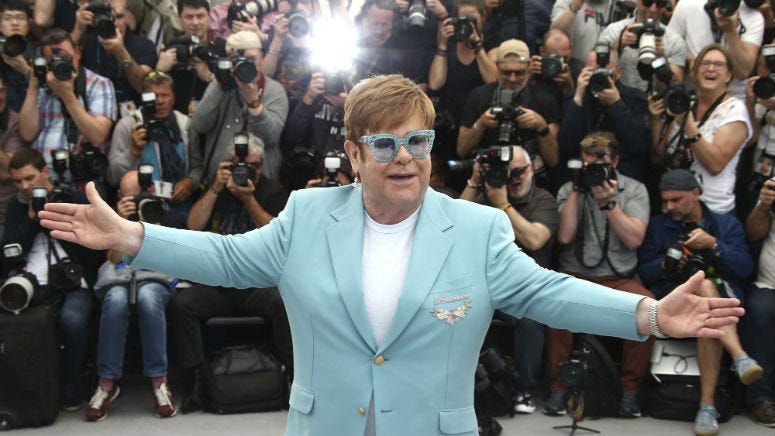 Elton John poses for photographers at the photo call for the film 'Rocketman' at the 72nd international film festival, Cannes, southern France, Thursday, May 16, 2019.