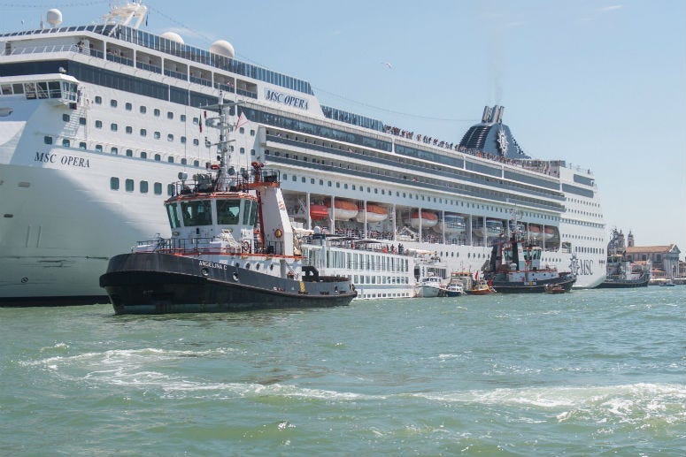 The damaged tourist river boat docked next to the cruise ship after Sunday's collision. 