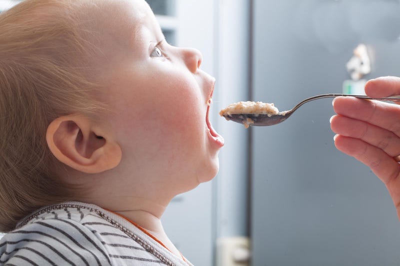 Baby eating baby food.