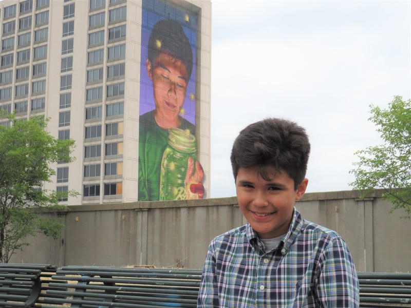 Sam Gonzalez, 10, of East Hartford poses with Hartford's new "Reawakening Wonder" mural, which bears his image, 6/29/23