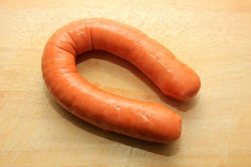 curled Polish sausage on table
