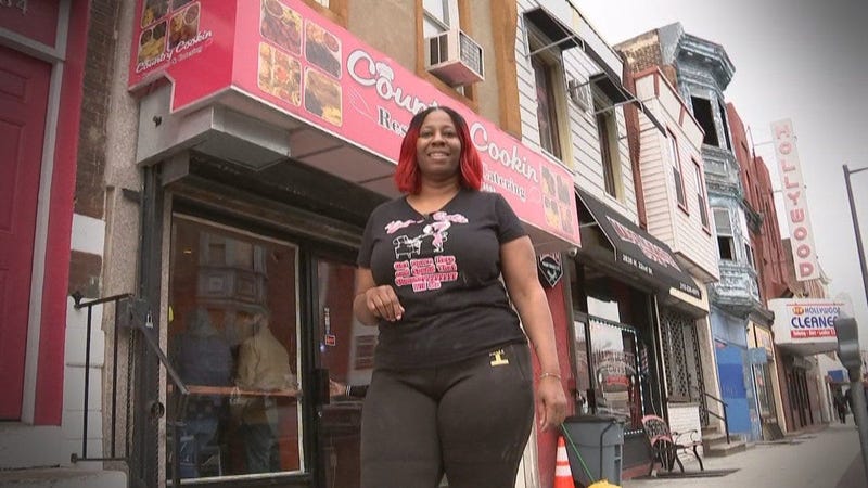 Saudia Shuler poses in front of her North Philly restaurant Country Cookin'. 