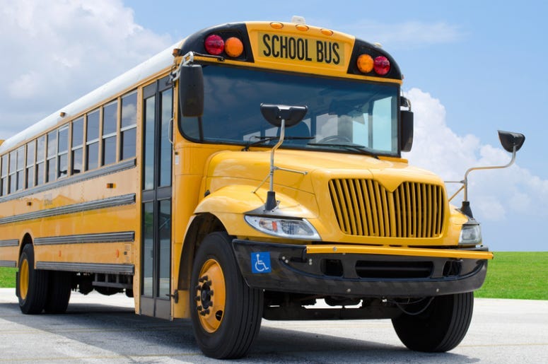 Yellow school bus on the blacktop on a beautiful sunny day