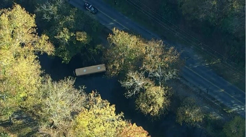 The Easton Area School District bus is shown partially submerged in Bushkill Creek on Monday morning.