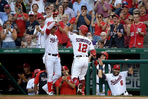 Kyle Schwarber celebrates with Juan Soto
