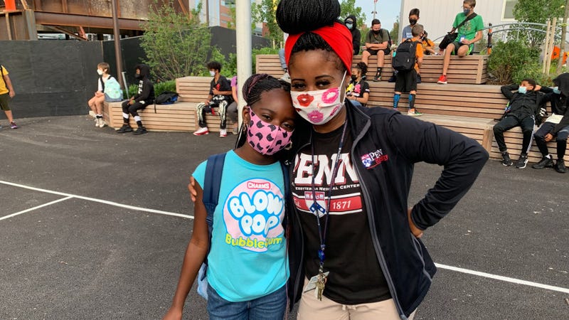 Dior, 11, and her mother Latora Brown wait for the day to start on the first day of the school year at Science Leadership Academy Middle School in University City, Philadelphia.