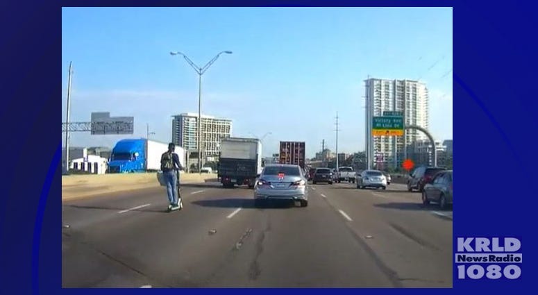 Man Riding Electric Scooter On Interstate
