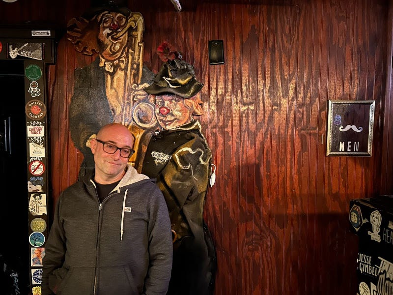 Brian “Scooter” Hassinger stands by the back wall of The Grape Room, one of his favorite spots in the venue.