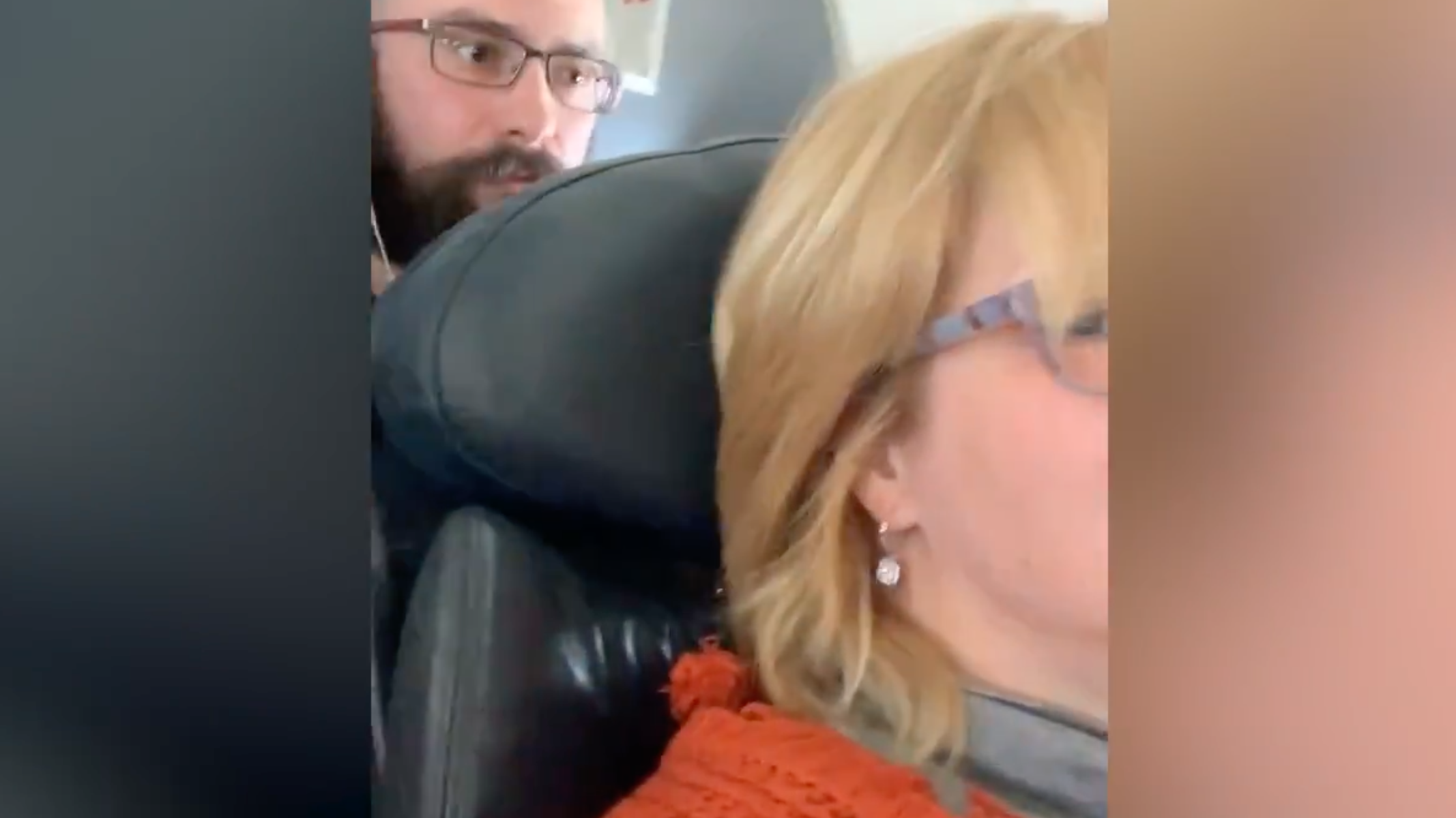 Passenger whose reclined seat was punched by man in viral video threatens to sue American Airlines