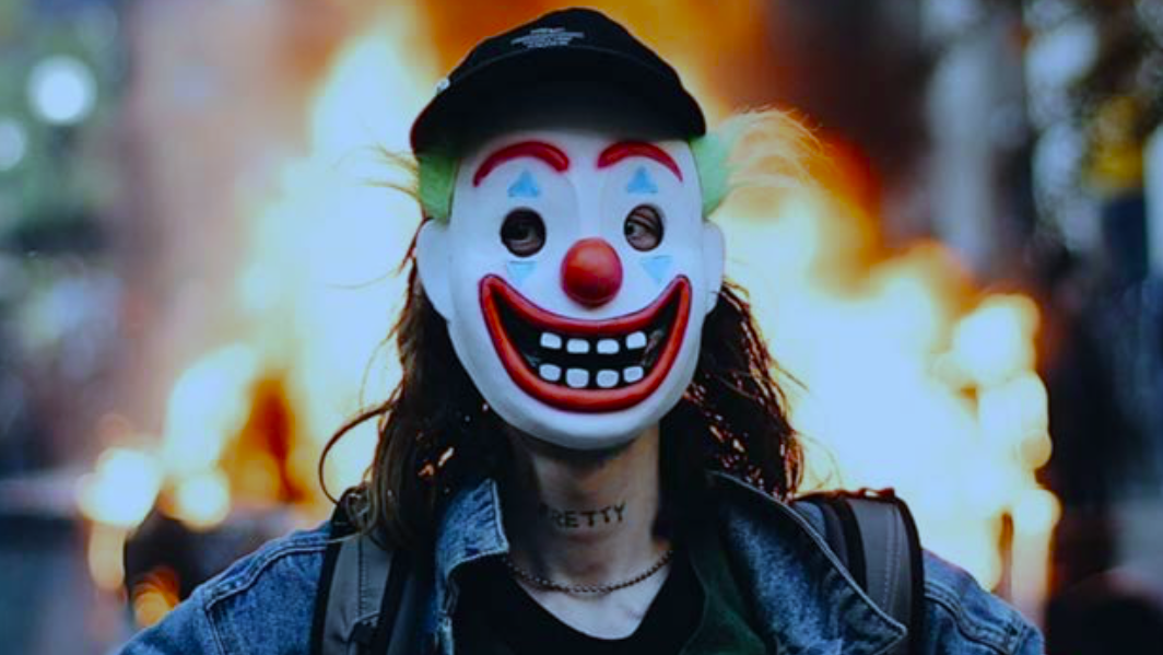 Feds Arrest 'Joker' Suspect After Police Car Fire, Say Neck Tattoo Was Giveaway