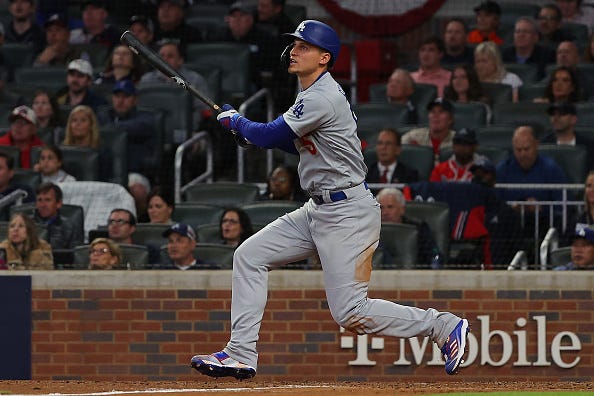 Corey Seager watches after hitting a ball into the outfield. 