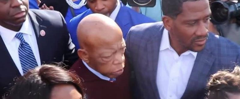 Atlanta Congressman John Lewis is escorted from a car to the crowds on the Pettus Bridge in Selma
