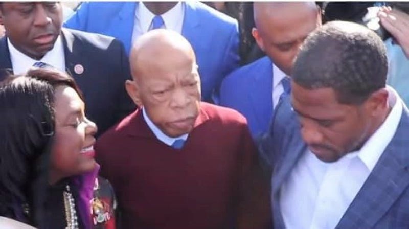 Congressman John Lewis prepares to join the many thousands on the Pettus Bridge