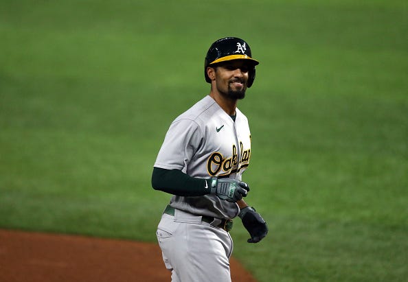 Marcus Semien smiles as he jogs around the bases with the A's. 