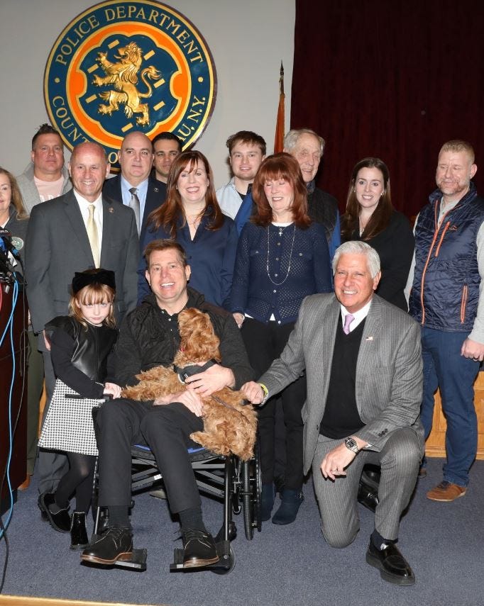 Nassau County Det. Ken Baribault, loved ones and police officials with his new service dog Lady on Jan. 15, 2025.
