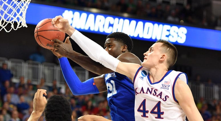 Kansas' Mitch Lightfoot battles for a rebound with Seton Hall's Angel Delgado in the second round of the NCAA tournament on March 17, 2018 in Wichita, Kansas.