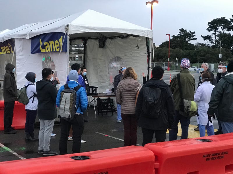 Healthcare workers receive a briefing before the opening of San Francisco's first mass vaccination site