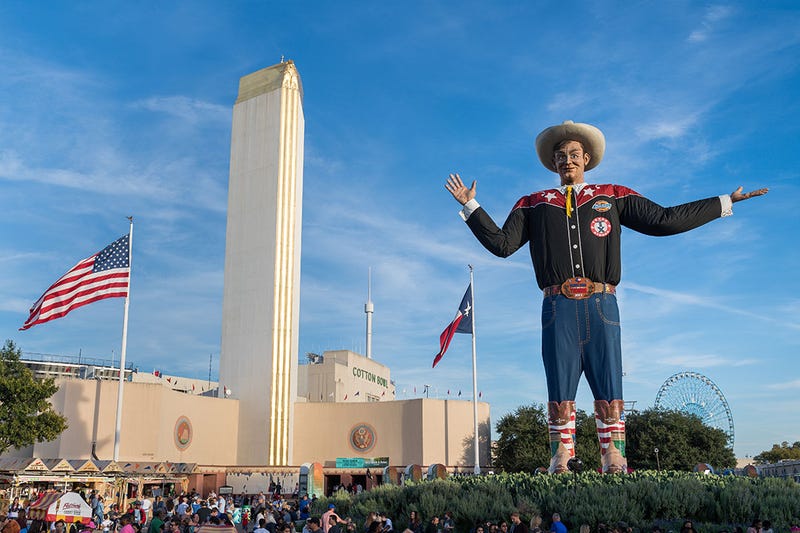 BIG TEX CIRCLE WITH TOWER BUILDING IN BACKGROUND
