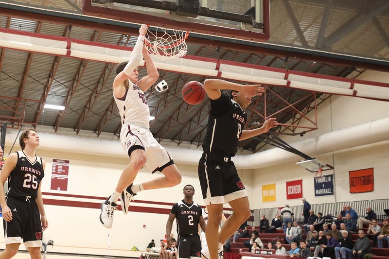 Swarthmore College senior forward Nate Shafer dunks for two.