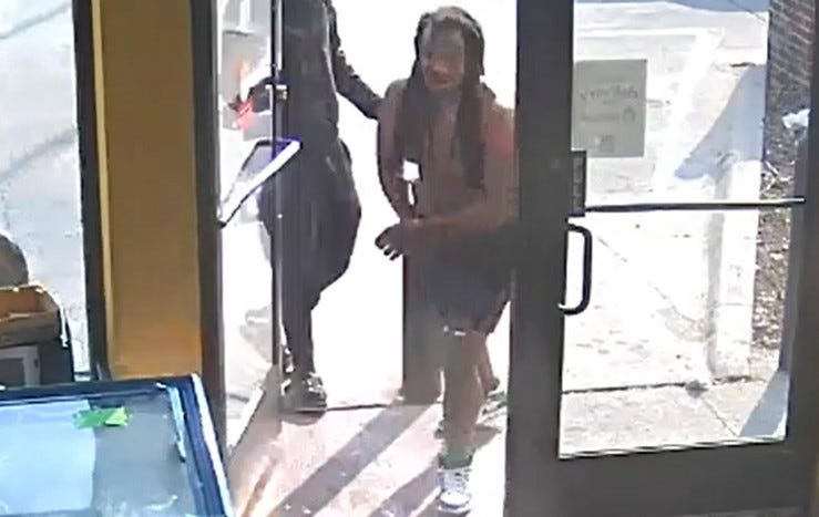 The shirtless gunman re-enters the store, before firing shots