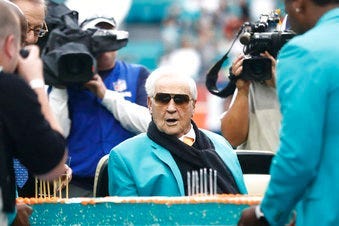 FILE - Former Miami Dolphins head coach Don Shula looks at a large cake celebrating the 1972 undefeated season and his birthday during half time at an NFL football game against the Cincinnati Bengals. (AP Photo/Brynn Anderson, File)