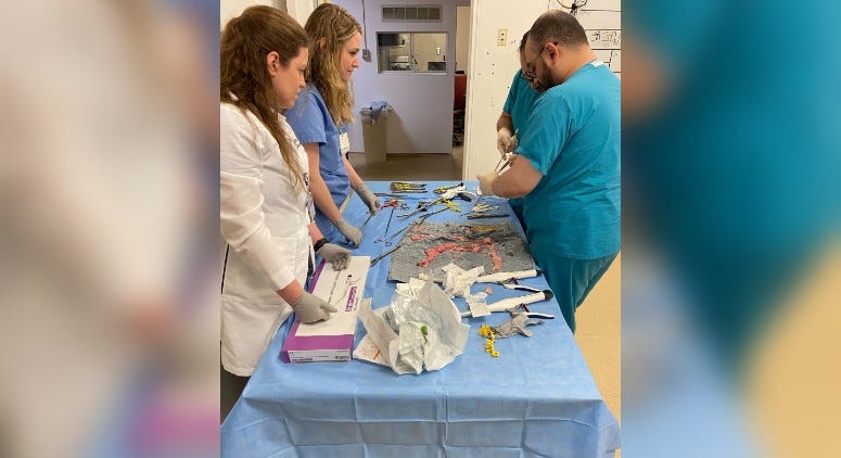 Surgery residents at Virtua’s Berlin Health and Wellness Center practice on pig intestines at the new simulation center.