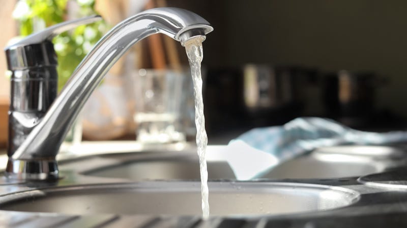 Water running from tap into kitchen sink
