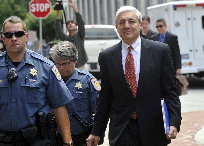 Former Penn State president Graham Spanier, accused of covering up Jerry Sandusky abuse allegations, leaves his preliminary hearing in Harrisburg in July 2013.
