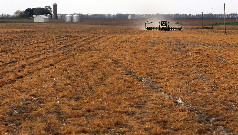 Farmer David Moose teaches his assistant Lee Curby about tractor technology as they plant corn on his no-till farm on April 19, 2016 in Auburn, Ill. Moose's land has not been tilled in the 32 years he has owned it.