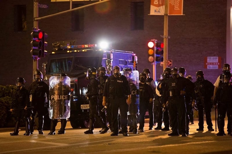 Police officers stand guard in St. Louis, Missouri, the United States, Sept. 17, 2017. Protesters smashed windows and other property in downtown St. Louis, Missouri Sunday night.
