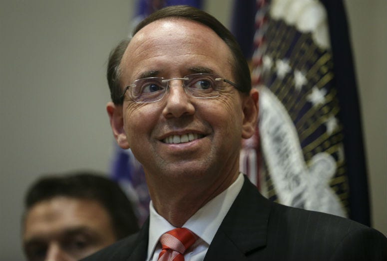 Deputy Attorney General Rod Rosenstein attends a signing ceremony by President Donald Trump as he signs bills intended to lower prescription drug prices during a ceremony in the Roosevelt Room of the White House in Washington, DC, October 10, 2018.