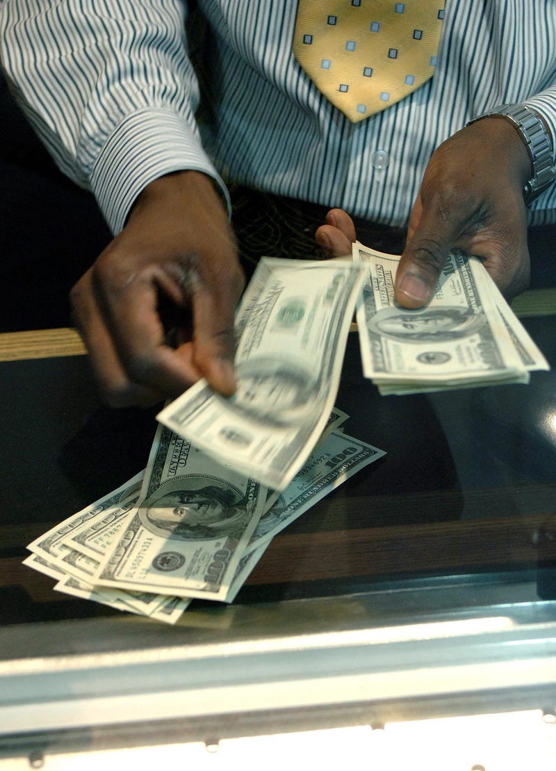 4/29/2019 - Embargoed to 0001 Monday April 29 File photo dated 30/11/06 of a member of staff counting $100 bills at a Bureau de Change in London. Currency sales for some long haul destinations have jumped this year figures from Post Office Travel Money sh