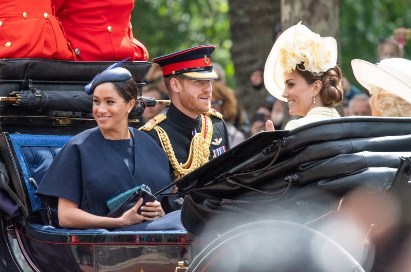 Meghan, Duchess of Sussex rides in an open carriage with Prince Harry, Duke of Sussex and Catherine, Duchess of Cambridge 
