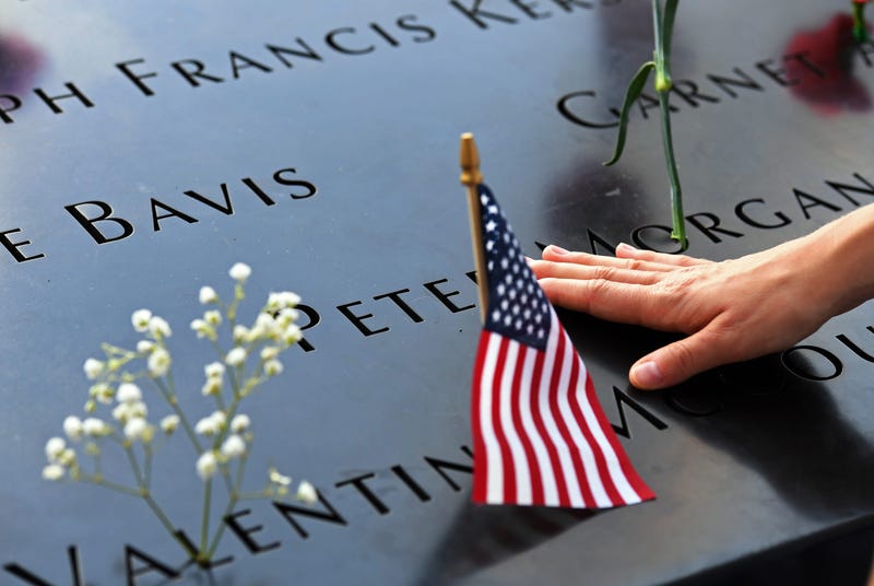 BEIJING, Sept. 13, 2019 (Xinhua) -- A woman touches a plate on which names of 9/11 victims were inscribed at the National September 11 Memorial and Museum in New York, the United States, Sept. 11, 2019.